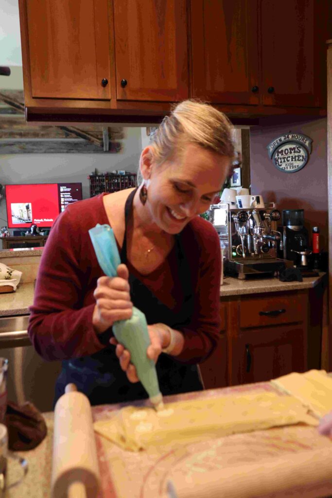 Woman Filling Ravioli Women hand fills fresh ravioli at PastaNooga's cooking class - Chattanooga Pasta Making Company.