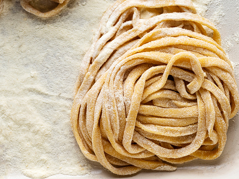 Fresh italian traditional pasta, Fresh raw uncooked pasta, Pasta Tagliatelle, Pasta nest, Italian pasta, Italian macaroni, Raw tagliatelle macaroni nest